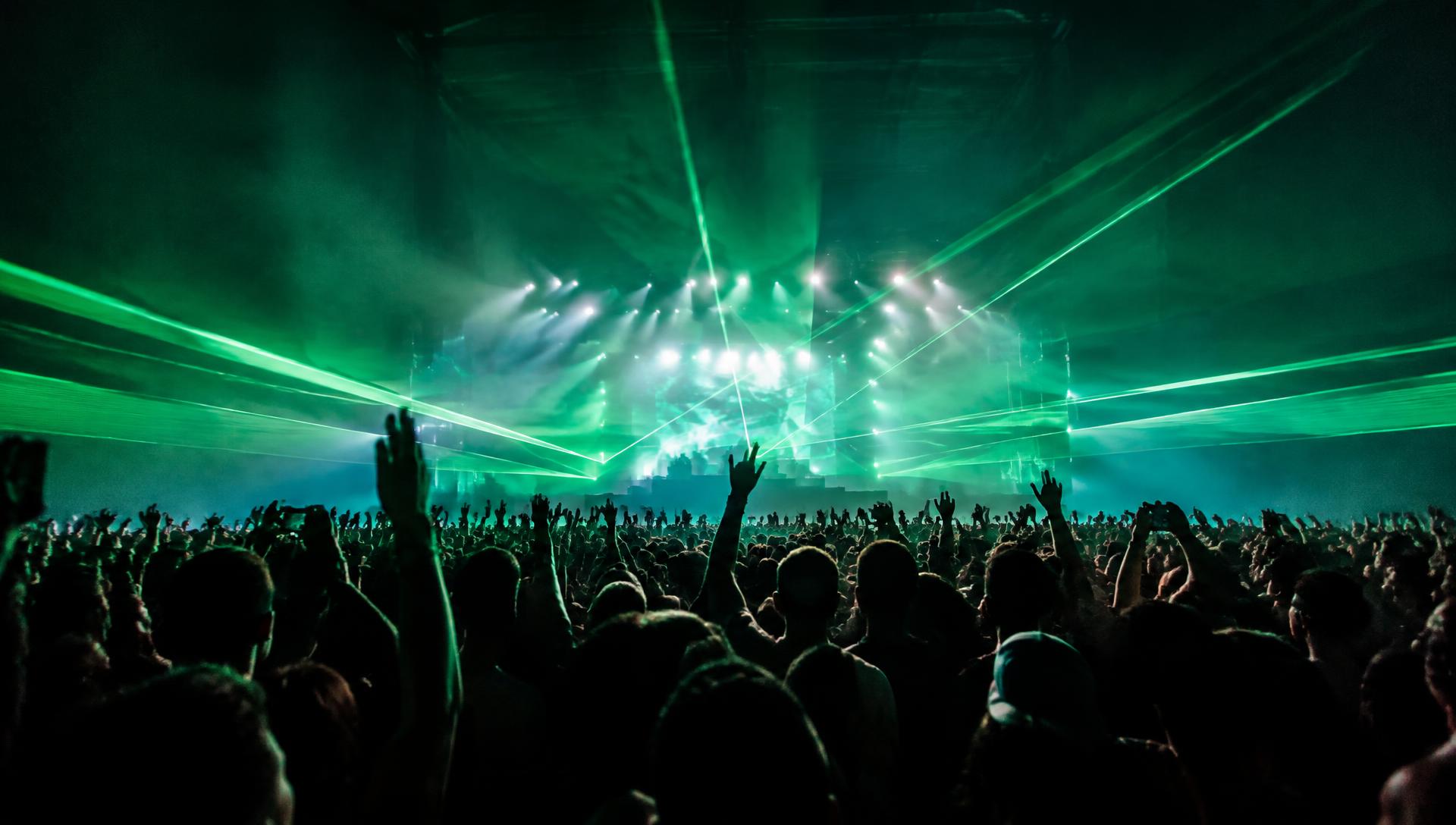 Live concert crowd beneath stage lights