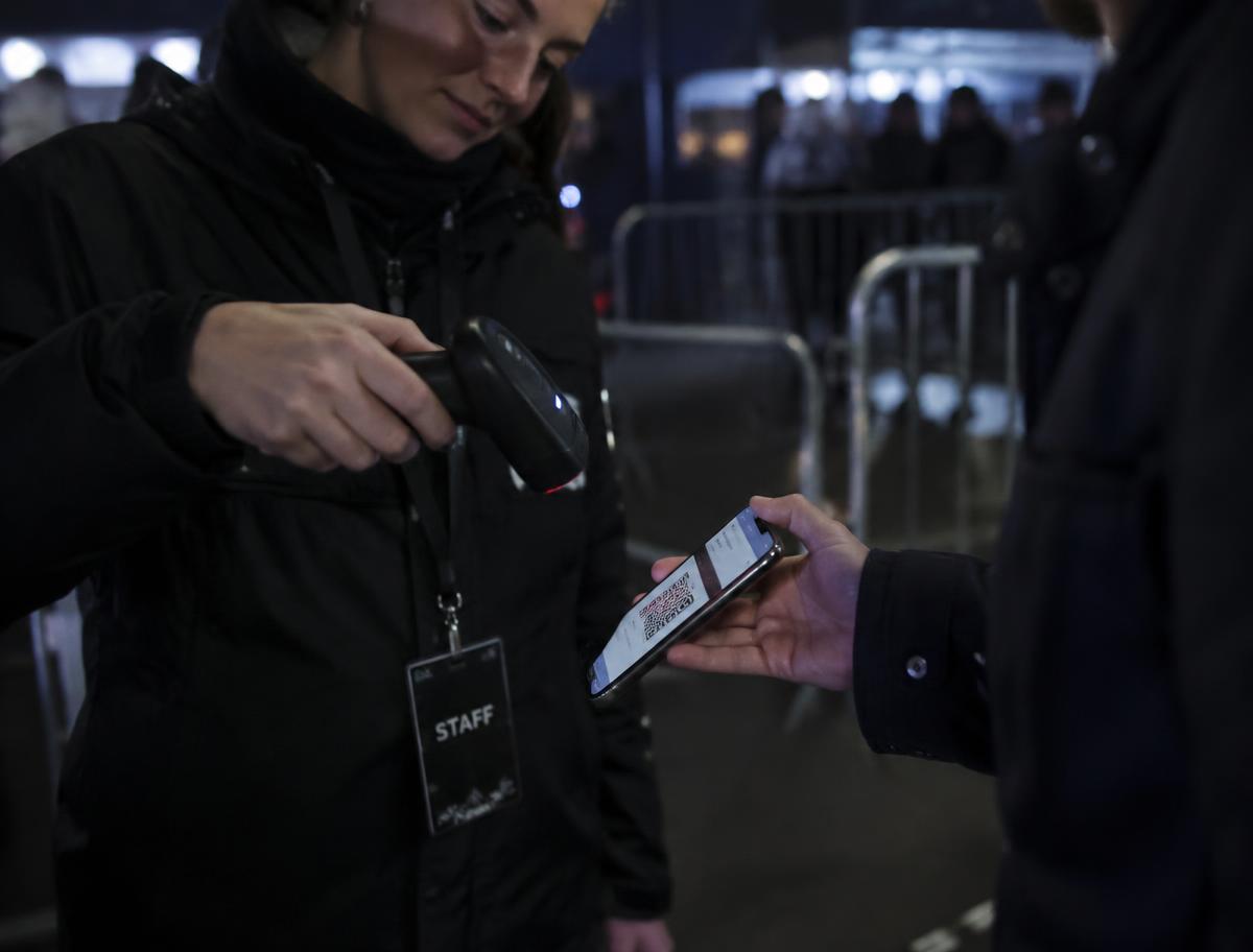 Event staff checking an attendee’s ticket at the entrance